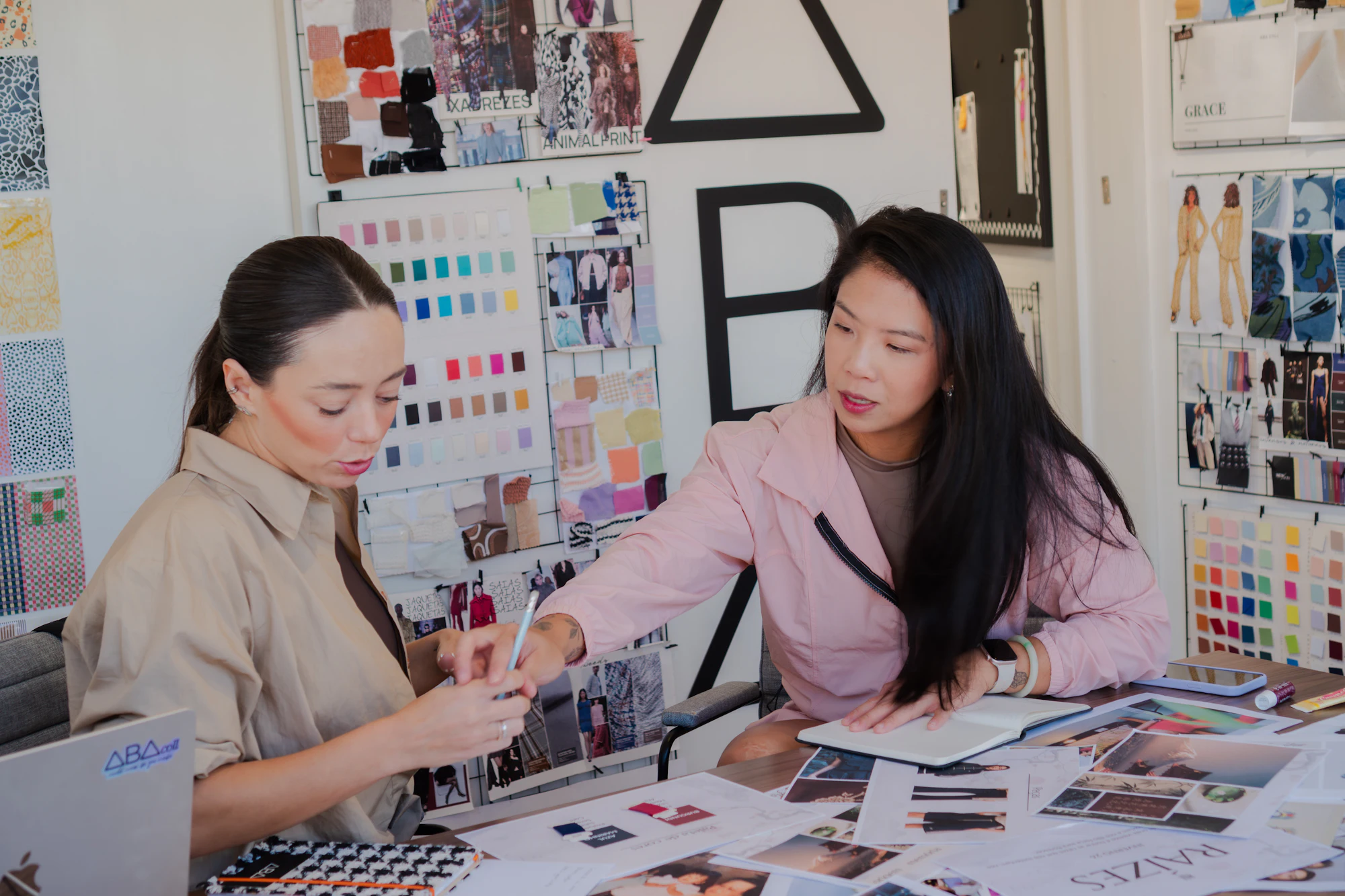 Two creatives reviewing a brand moodboard